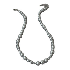 Silver grey pearl necklace with gradient size beads and lobster clasp on white background