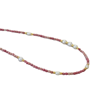 Pink gemstone beaded necklace with freshwater pearls and gold accents on white base