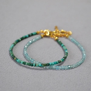 Close-up of minimalist handmade beaded bracelets with turquoise and aquamarine stones
