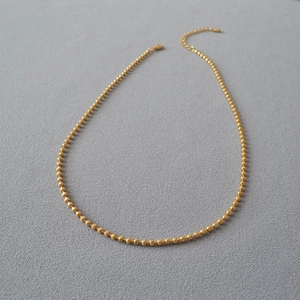 Detail view of the brass gold plated glitter chain featuring adjustable lobster clasp