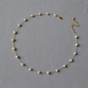 Detailed view of irregular freshwater pearls on gold-plated brass chain with lobster clasp