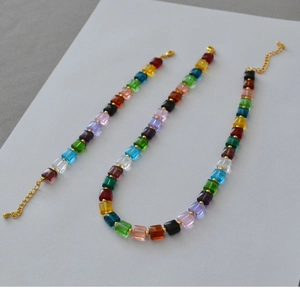 Close-up of rainbow square beads necklace with golden lobster clasp and extension chain