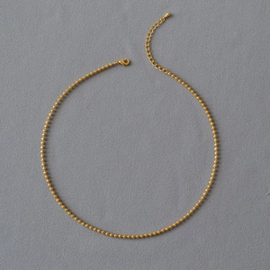 Detail of gold-plated brass bead chain necklace with lobster clasp and adjustable extender