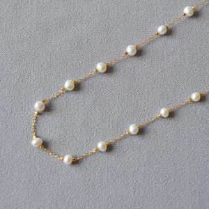 Elegant gold-plated brass necklace featuring irregular freshwater pearls on thin chain