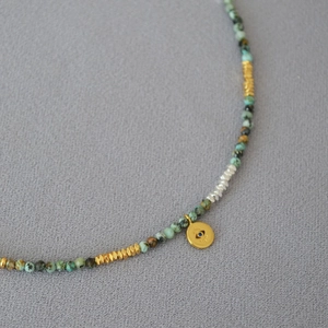 Bohemian turquoise beaded necklace with evil eye pendant and gold geometric spacers