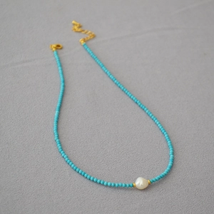Handmade necklace with turquoise beads, black spinel, and a baroque freshwater pearl
