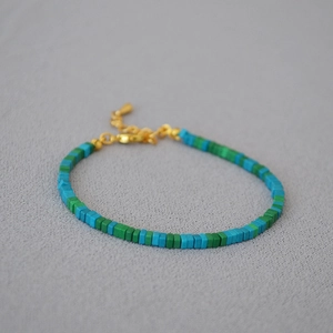 Minimalist beaded bracelet with green and blue square beads and gold adjustable chain
