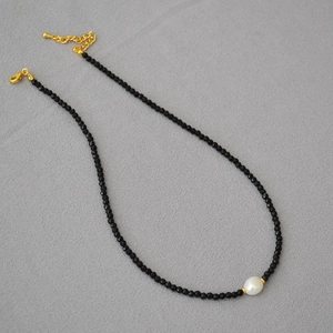 Detail of beaded choker with black spinel, baroque pearl and gold lobster clasp closure