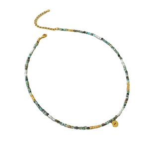 Boho turquoise bead necklace with silver nuggets and evil eye pendant on white background