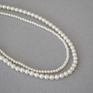 Elegant double-layered white pearl necklace with glossy strands for a minimalist style