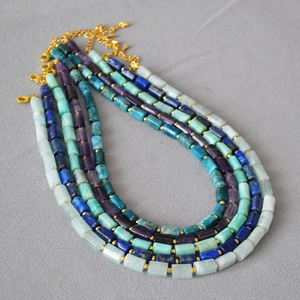 Detail of semi-precious stone necklaces with gold spacer beads and lobster clasp