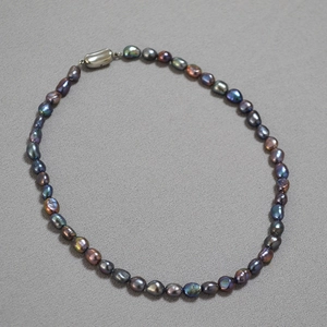 Detailed macro shot of irregular Tahitian green baroque pearls with colorful metallic luster