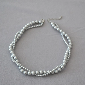 Detail of double-layer faux pearl necklace with silver-grey finish and adjustable chain