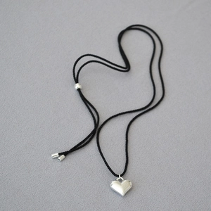 Minimalist adjustable black cord necklace with a polished silver heart pendant