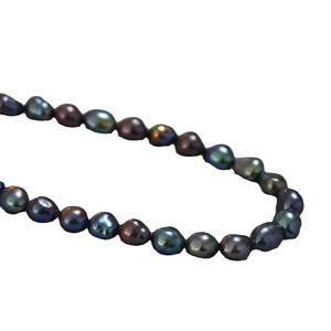 Baroque tahitian green luster pearl necklace with colorful iridescent finish on white base
