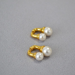 Chic gold double pearl earrings featuring large and small white pearls on minimalist mounts