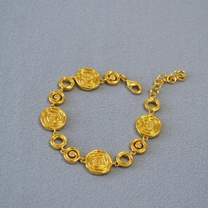 Vintage gold-plated brass bracelet featuring rose flower links and adjustable chain