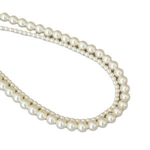 Elegant double-layered faux pearl necklace with glossy cream beads on white background
