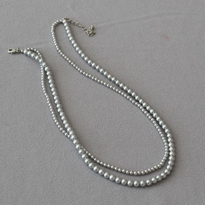 Close-up of double-layer silver grey pearl necklace with adjustable metal clasp detail