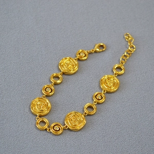 Vintage style gold plated brass bracelet with embossed rose design and crystal accents