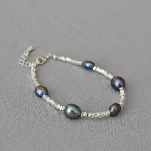Macro view of Tahitian pearl necklace with irregular silver beads and lobster clasp