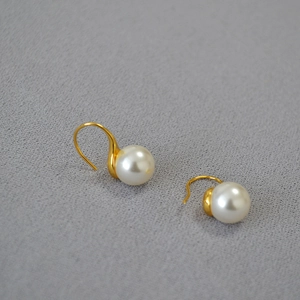 Détail de perles blanches rondes 10mm avec crochets d'oreilles dorés élégants