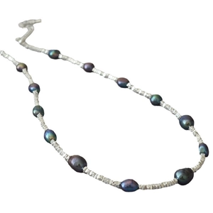 Irregular Baroque Tahitian pearls necklace with sparkling silver nuggets on white background