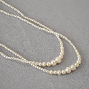 Detail of double-layer cream pearl necklace with gradient sizing and elegant luster