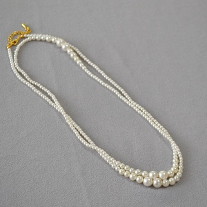 Close-up of double-layer gradient pearl necklace with gold-plated lobster clasp and chain