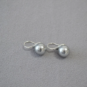 Elegant 925 silver plated earrings with high-luster round grey pearls on a soft grey surface