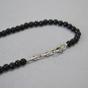 Elegant black onyx beaded necklace with silver U-link chain and modern clasp design