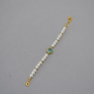 Elegant beaded bracelet with white pearls, a green oval gem, and gold-plated accents