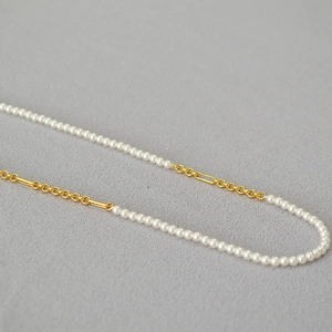 Elegant gold plated brass necklace with small white pearls and geometric chain link