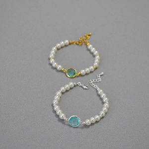 Minimalist pearl bracelet with light blue faceted crystal in gold and silver finish