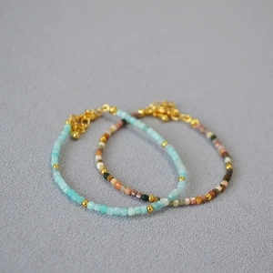 Minimalist beaded bracelets with blue and earthy faceted stones and gold beads accents