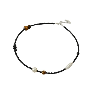 Asymmetric beaded necklace with black onyx, tiger eye stones, and baroque pearls