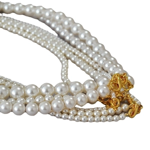 Elegant multi-layer round pearl necklace with golden interlocking figure-8 clasp design