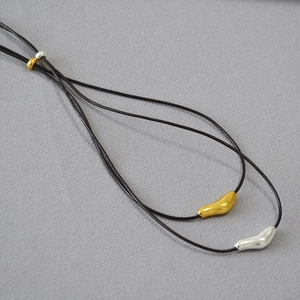 Minimalist brass bird necklace with adjustable leather cord and two-tone metal pendants