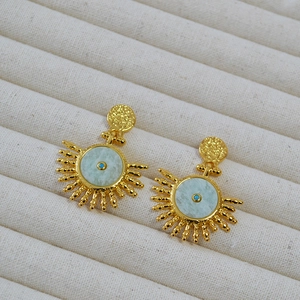 Detail of vintage bohemian sun earrings with amazonite stone and textured gold plating