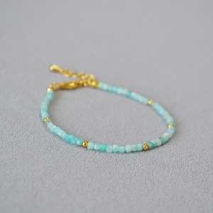 Minimalist gold beaded bracelet with sky blue faceted stones and adjustable lobster clasp
