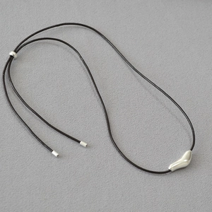 Minimalist silver abstract bird pendant necklace on dark brown cord with adjustable slider