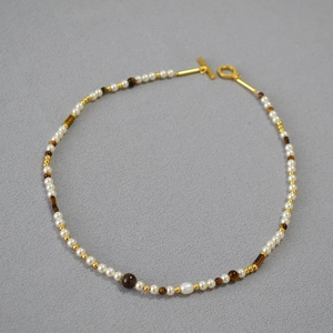Elegant beaded necklace with white pearls, brown tiger eye stones and golden OT clasp