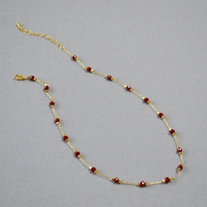 Gold plated brass necklace featuring faceted red cinnabar beads and lobster clasp