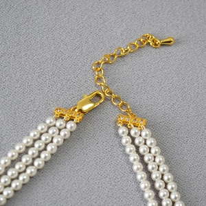 Elegant multi-layer pearl necklace with golden clasp and adjustable extension chain