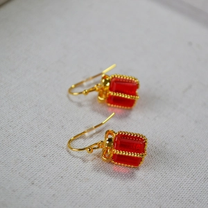 Festive red crystal candy box earrings with gold bow detail and minimalist hook style