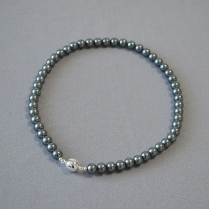 Macro shot of dark grey Tahitian style pearls with silver magnetic ball clasp and mirror luster