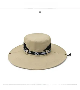 Detail of khaki outdoor sun hat with wide brim, chin strap, and Tornado-14 ribbon