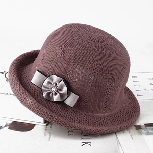 Detail of knit sun hat featuring breathable mesh, lace flower and rhinestone decoration