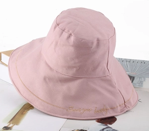 Pink wide brim cotton sun hat with gold Seek Your Beauty embroidery on the brim