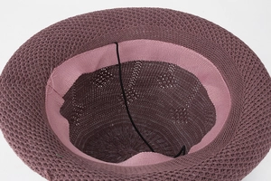 Detail of purple knitted sun hat showing sweatband and adjustable chin strap